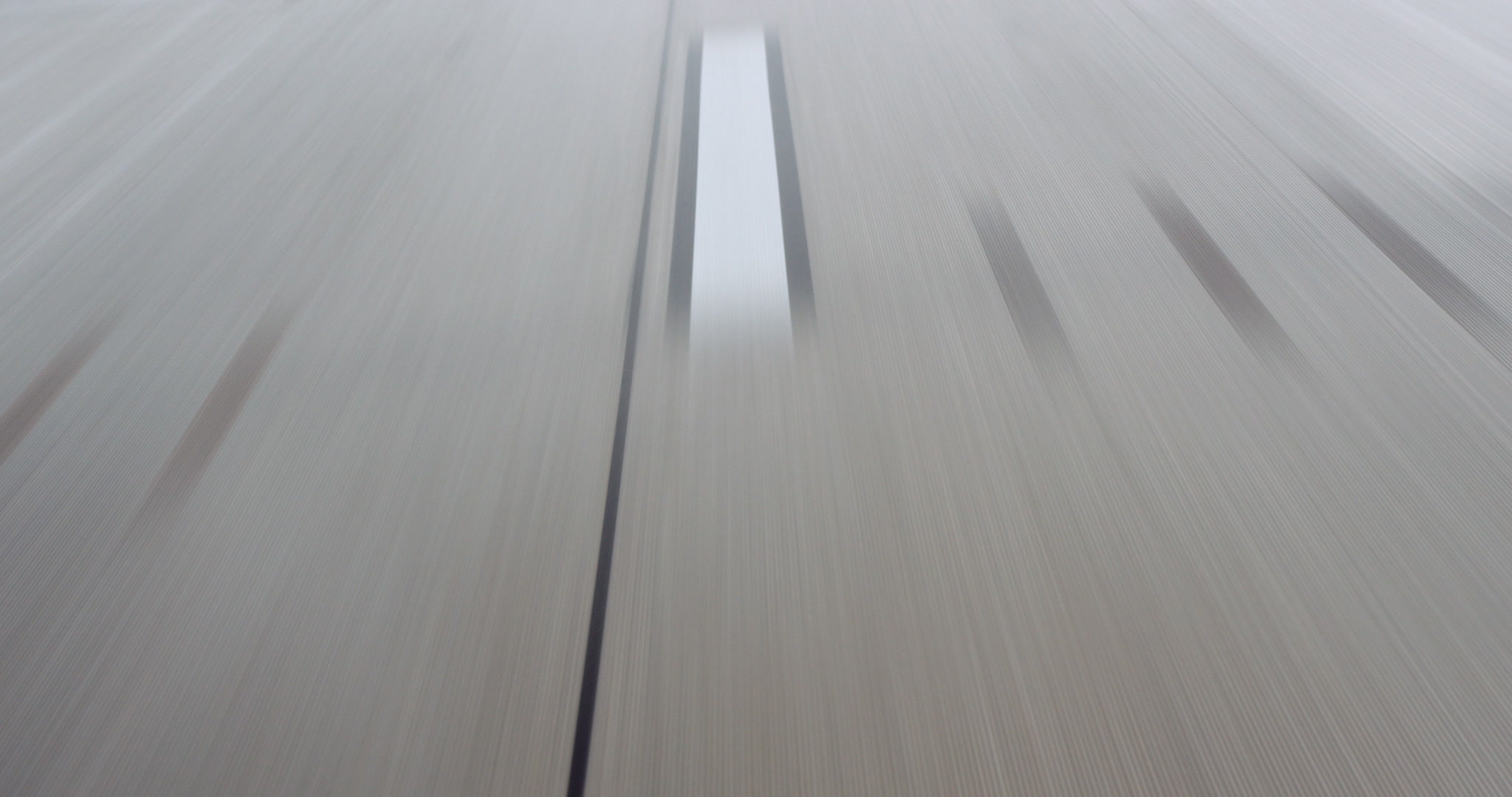 Close-up of wet highway with white stripes, car POV, 4K