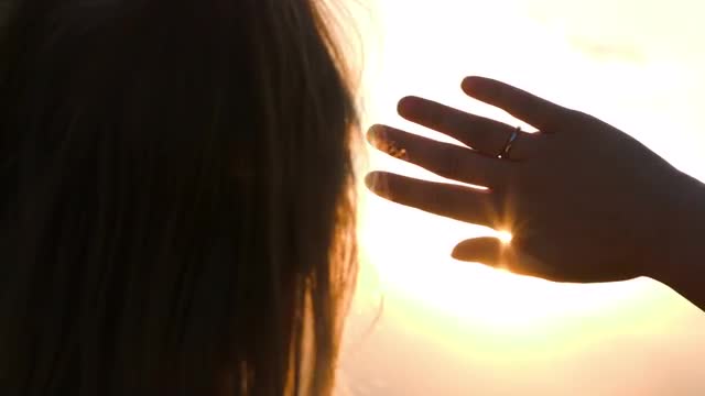 Woman looking into distance hiding from the sun