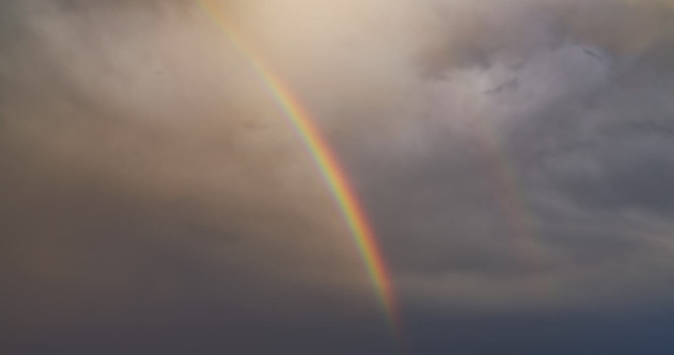 Close-up of rainbow in stormy sky, real-time, 4K