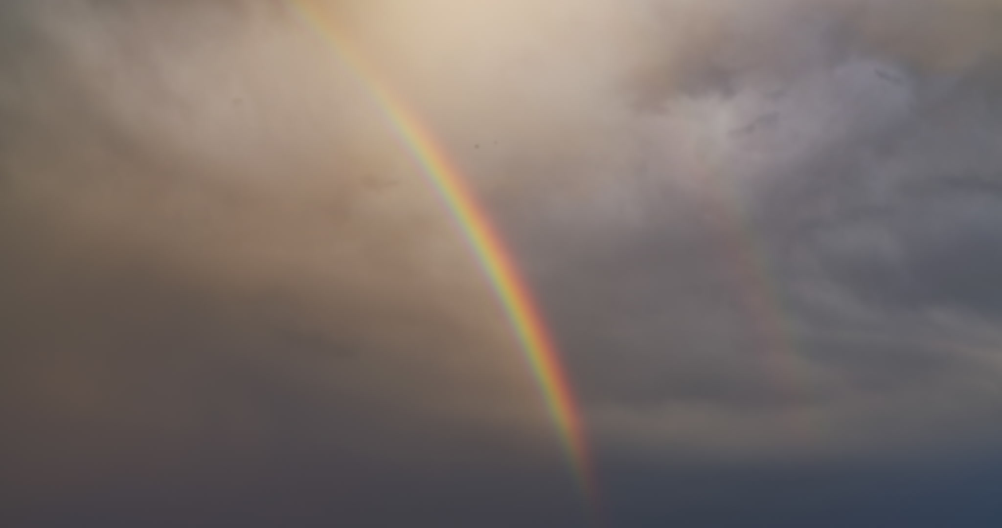 Close-up of rainbow in stormy sky, real-time, 4K