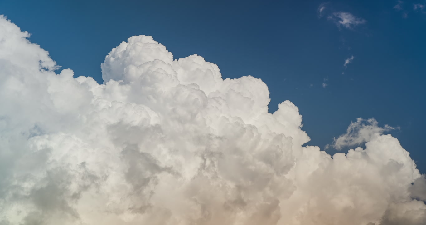Big, bright towering cumulus clouds in blue sky, building storm, 4K, real-time