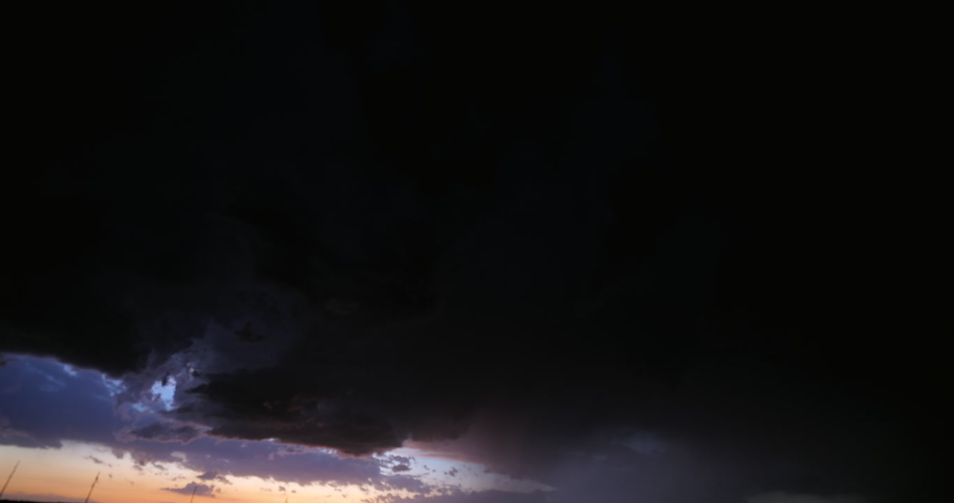 One minute long shot of lightning in dark, stormy sky at dusk, 4K