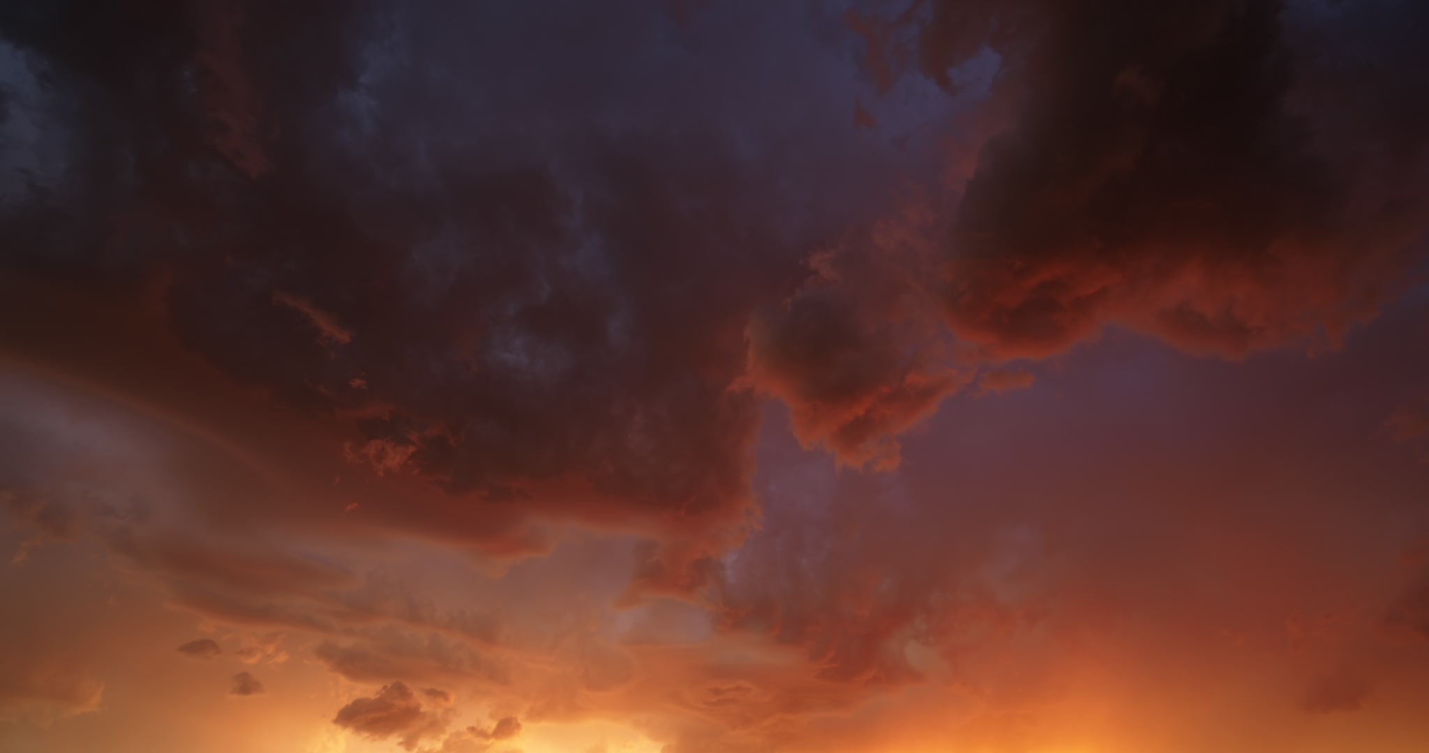 Long-durtion shot, stormy sky painted orange and blue at sunset, real-time, 4K