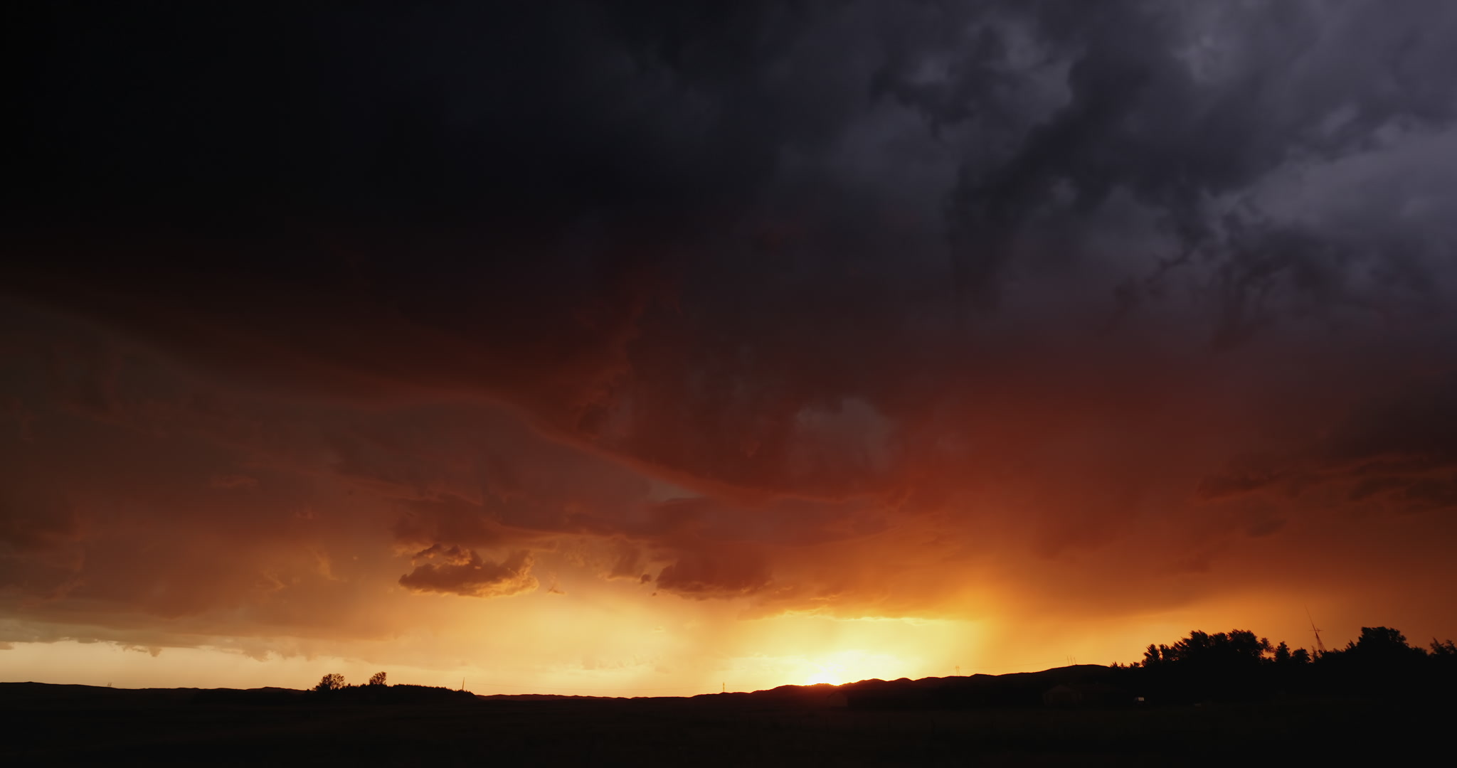 Orange stormscape with forked lightning, setting sun, Nebraska sand hills, 4K