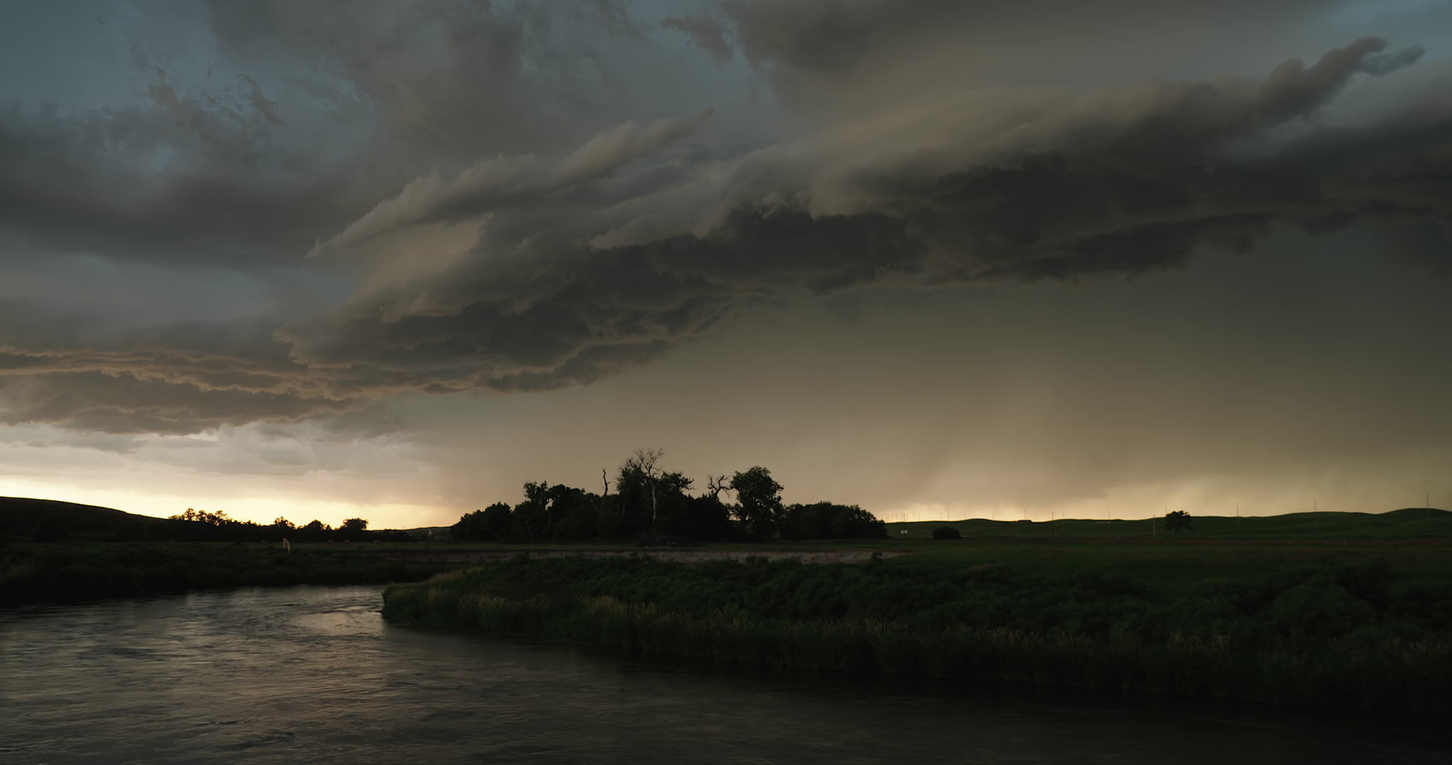 Lightning flashes, dark storm approaching, Middle Loup River, Nebraska, 4K