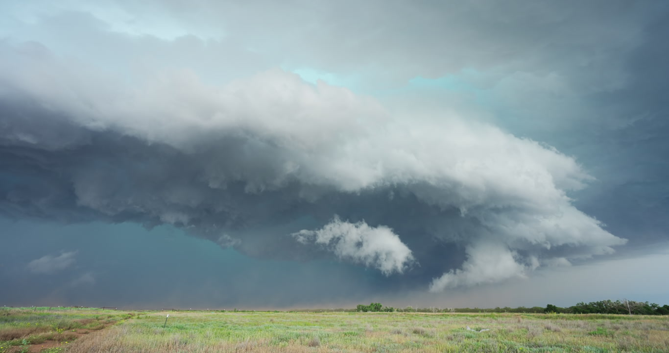 Large thunderstorm with shelf cloud and blowing dust drifts across Texas prairie, 4K