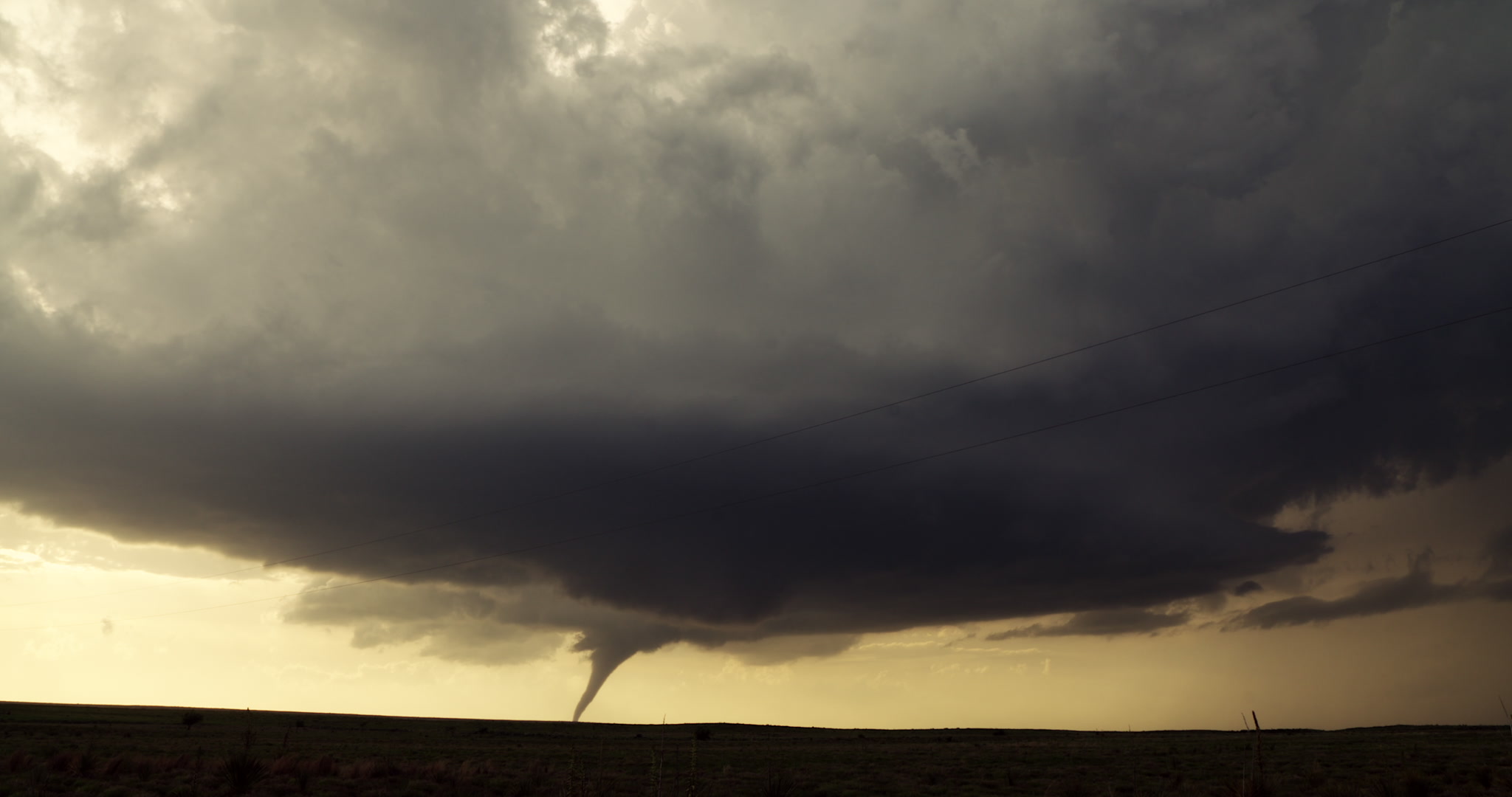 Tornado - wide shot of tornado beneath supercell thunderstorm, Oklahoma prairie, 4K