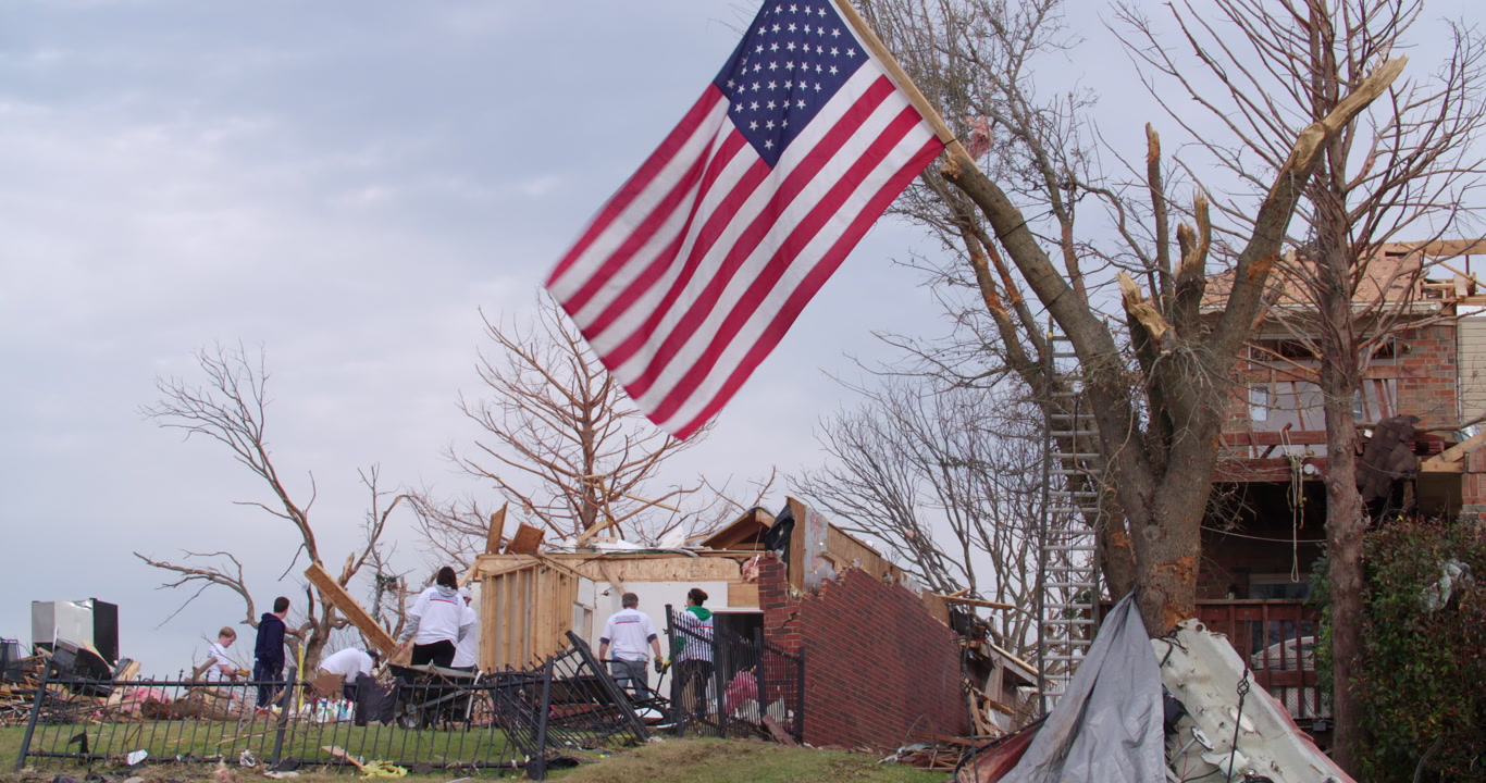 Tornado damage and aftermath - American flag over damaged area, cleanup, 4K