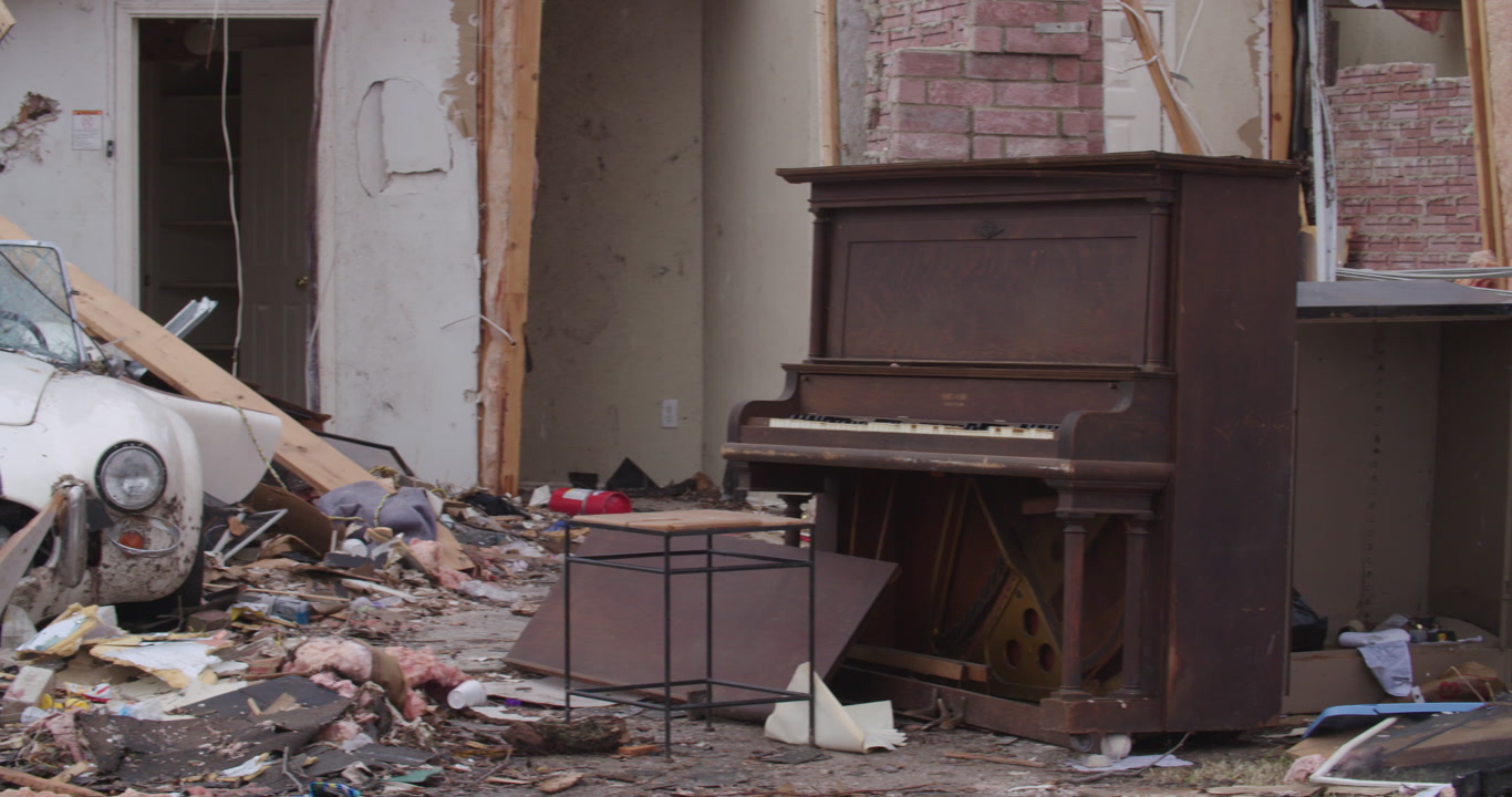 Tornado damage and aftermath - pan left, piano and two sports cars, 4K