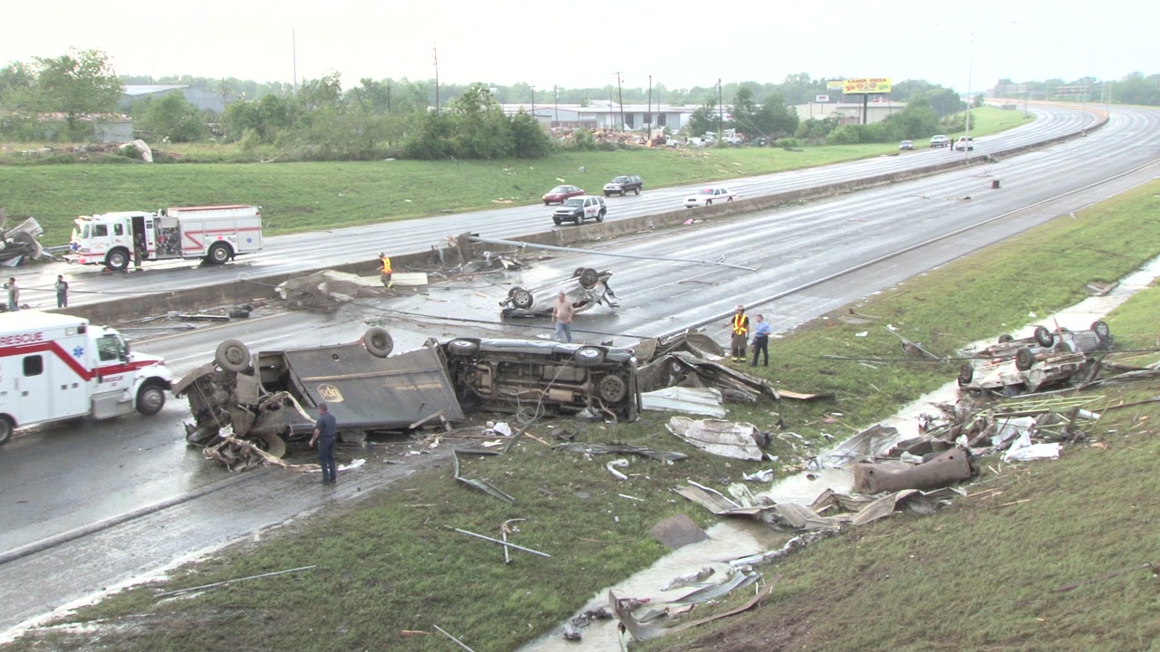 Tornado damage and aftermath - Delivery truck, cars strewn across highway, first responders arrive