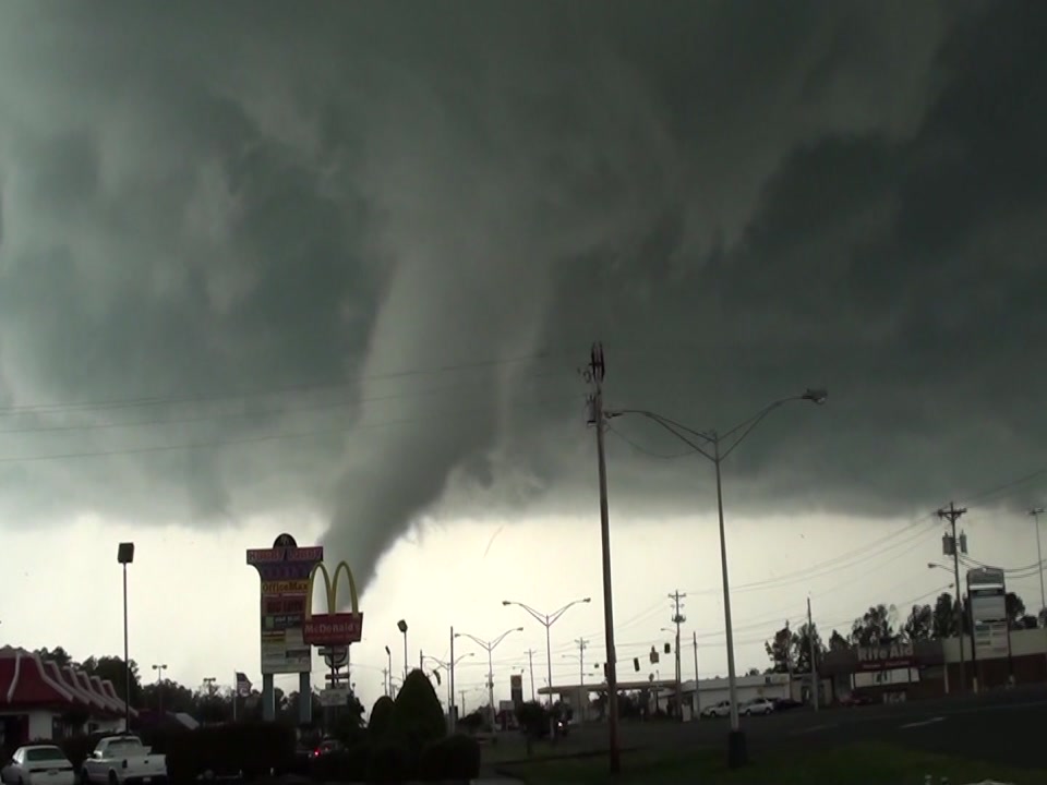 Tornado - destructive tornado in city passes behinds McDonalds sign