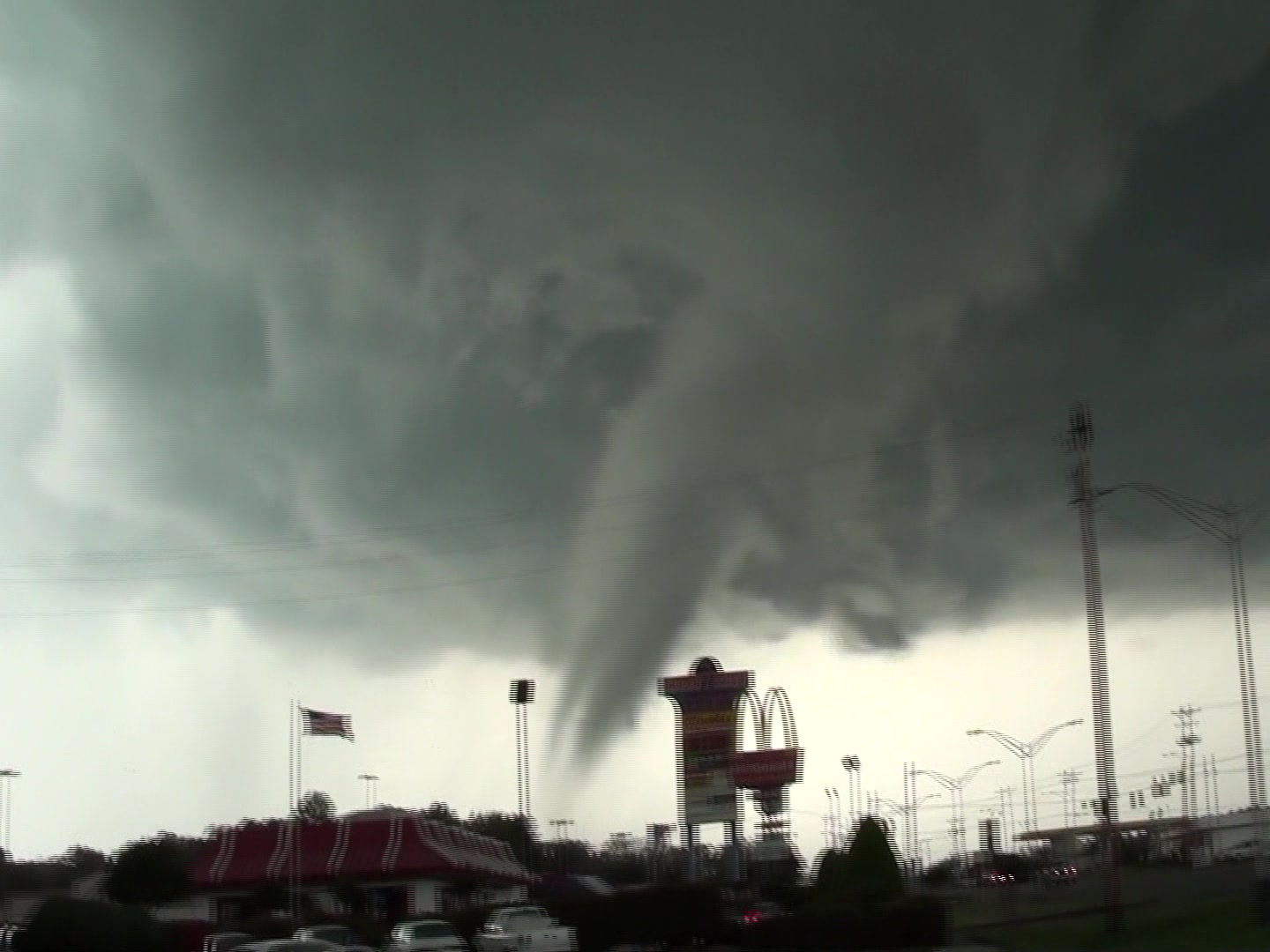 Tornado - destructive tornado in city passes behinds McDonalds sign