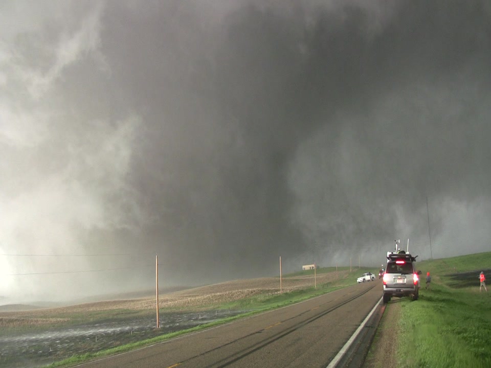 Tornado - massive tornado crosses highway, storm chaser parked right side