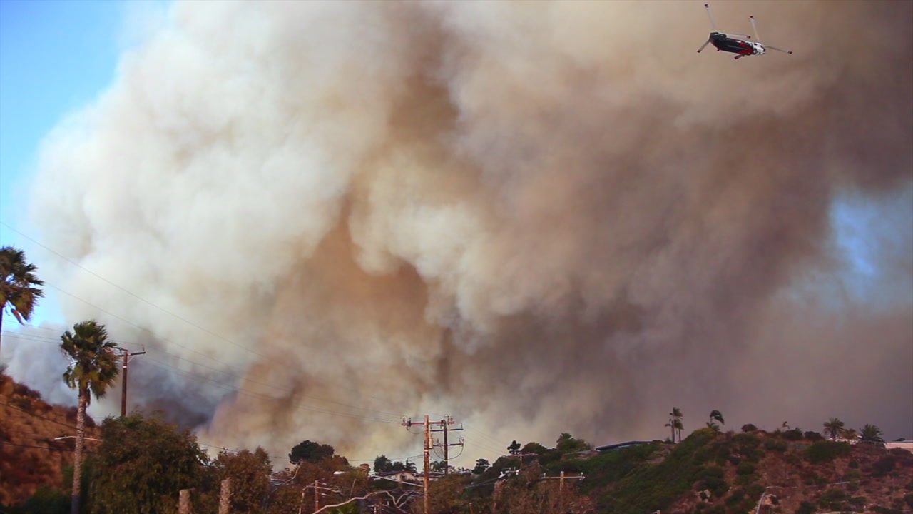 Helicopter flies over smoke - Historic Palisades Fire, January 2025, 4K