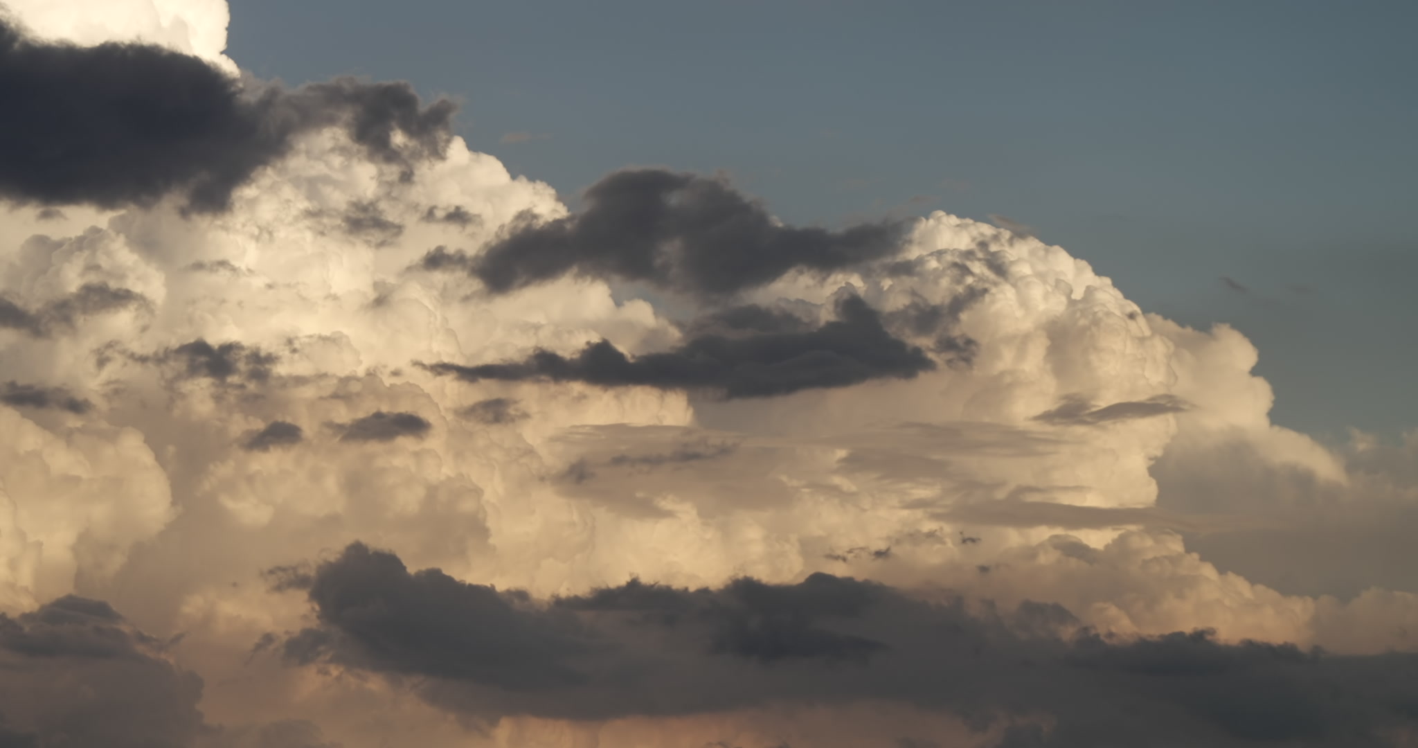 Close-up of thunderstorms developing in late day sunlight, time-lapse, 4K