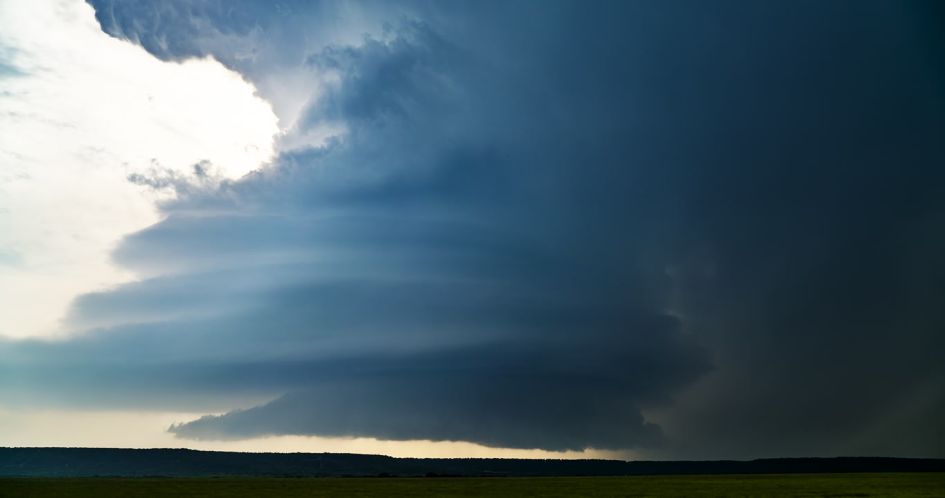 Blue supercell thunderstorm approaches at dusk, 4K