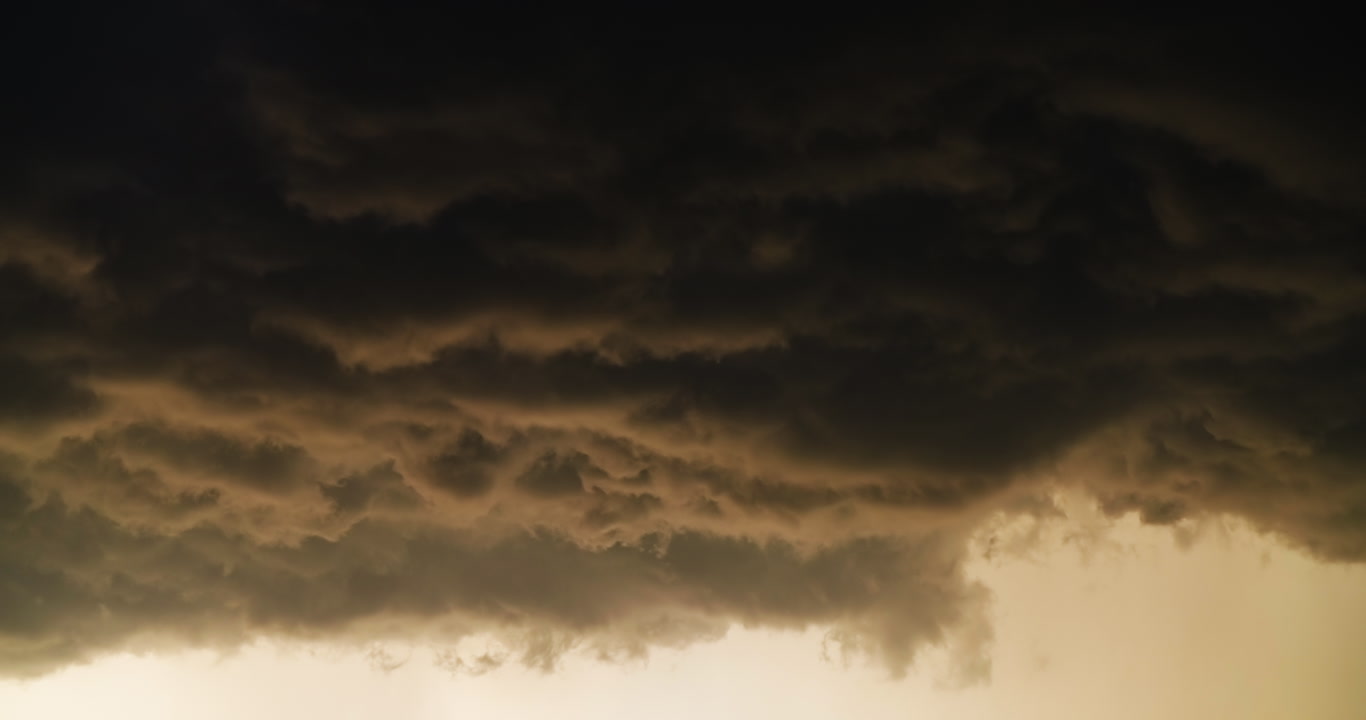 Scary but beautiful storm clouds drift by, sky only, golden hour, real-time, 4K