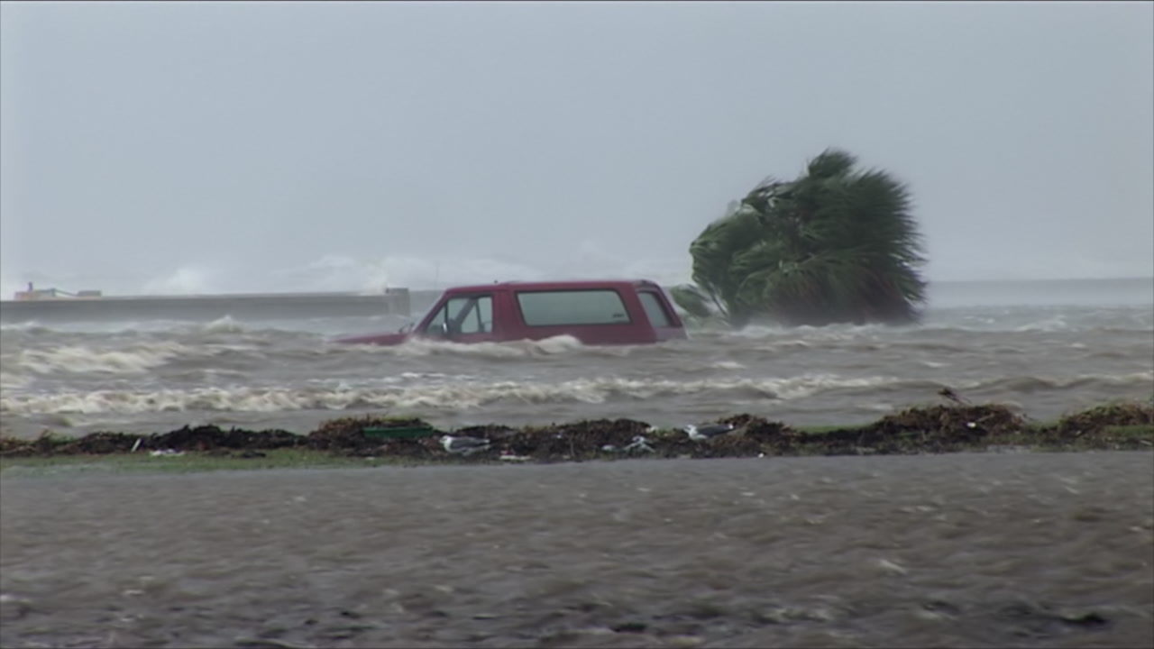 Red SUV shoved by storm surge - Hurricane Gustav, Mississippi, HD 1080