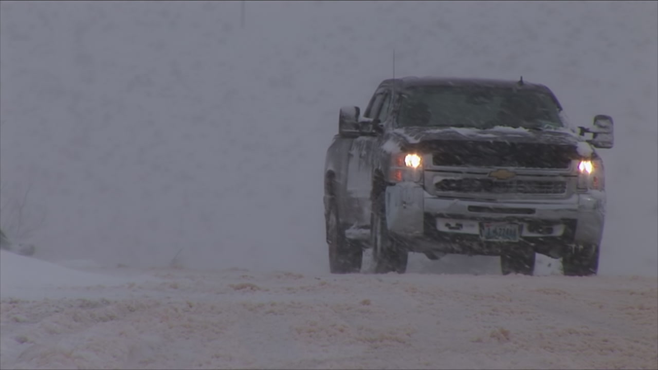 Cars drive on snow packed roads - winter storm, HD 1080