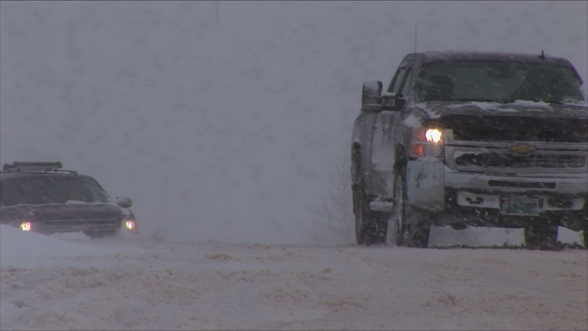 Cars drive on snow packed roads - winter storm, HD 1080