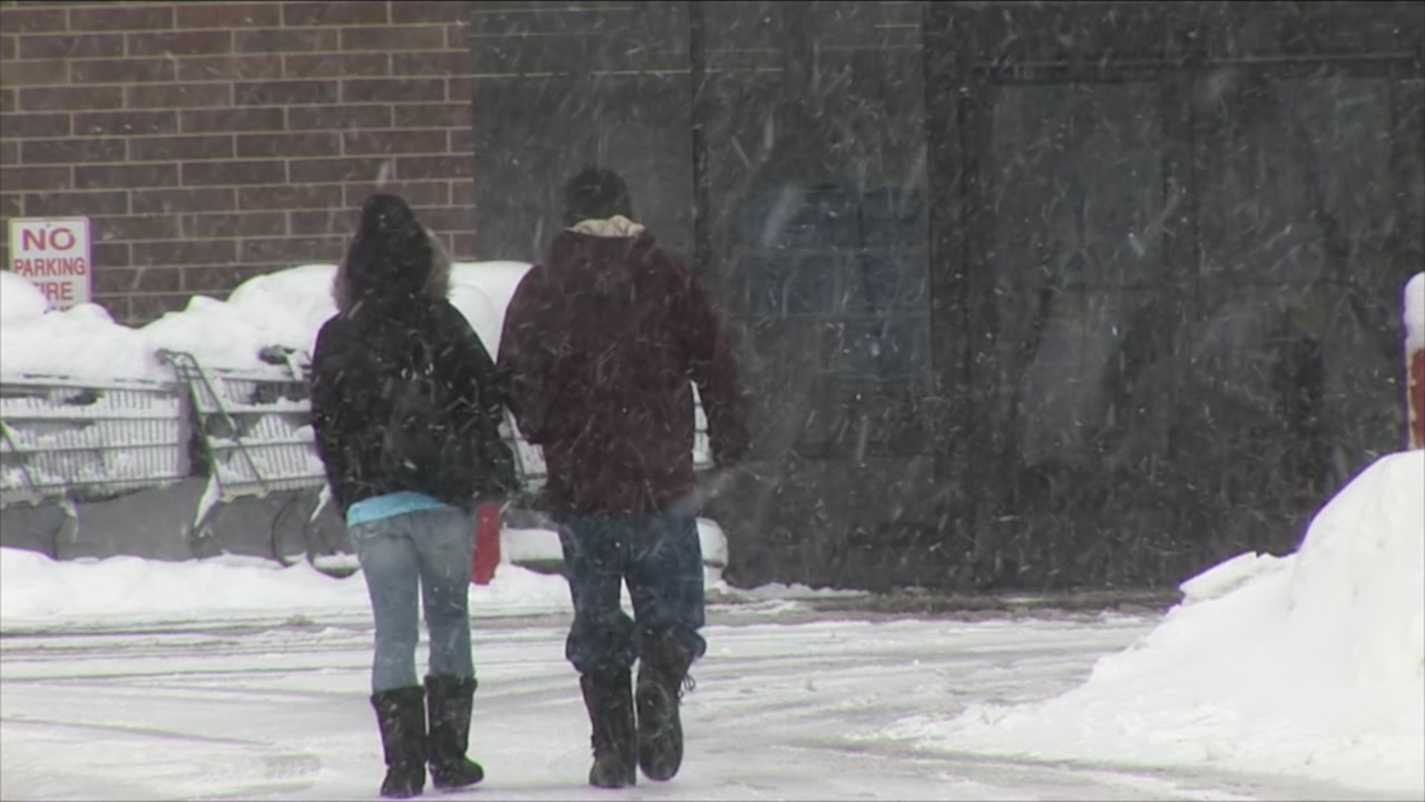 Two people walk into store - winter storm, HD 1080