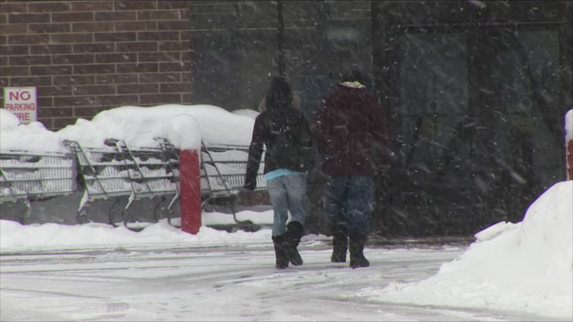 Two people walk into store - winter storm, HD 1080