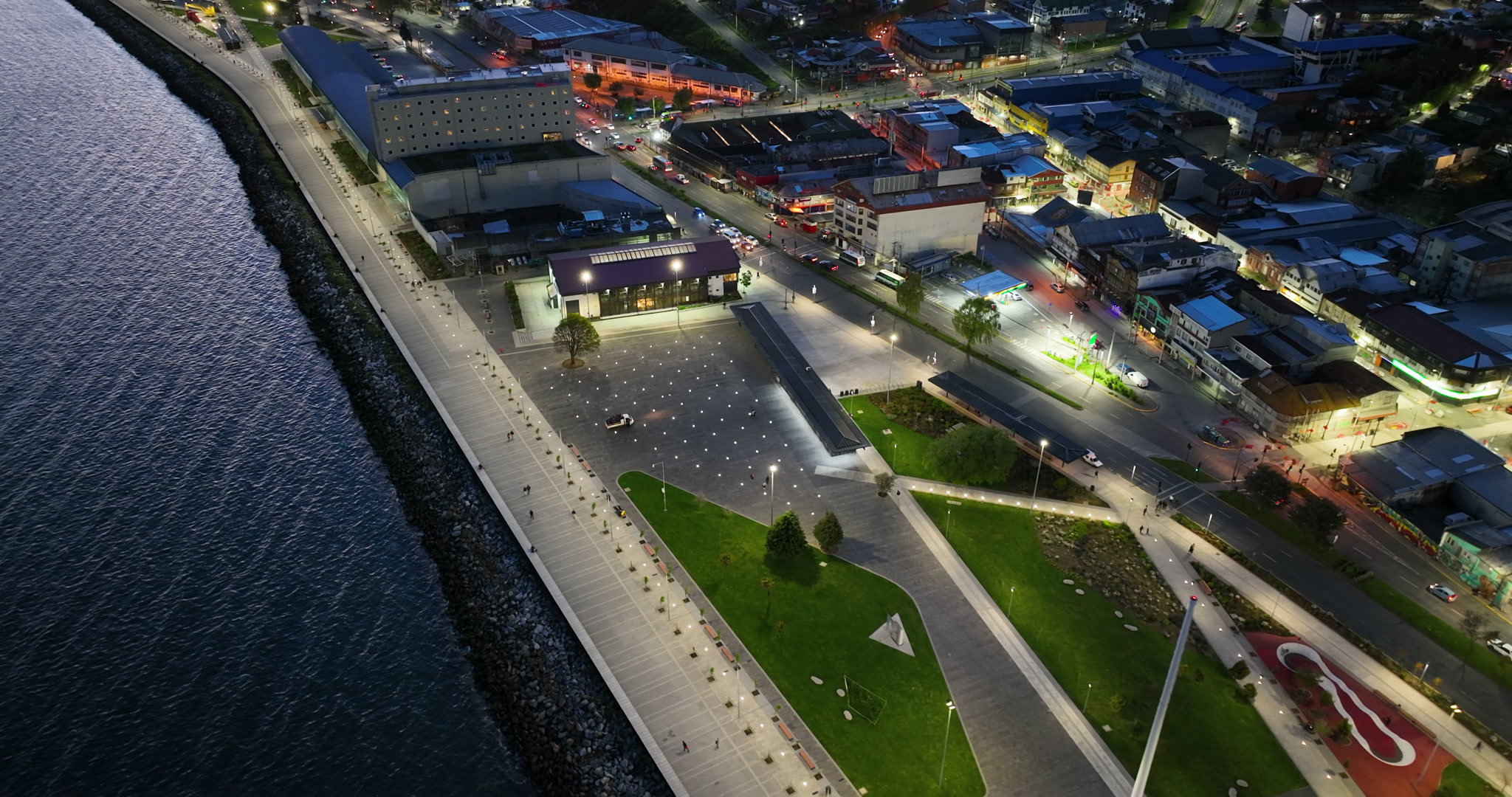 Aerial Tracking Left Over Illuminated Waterfront Park