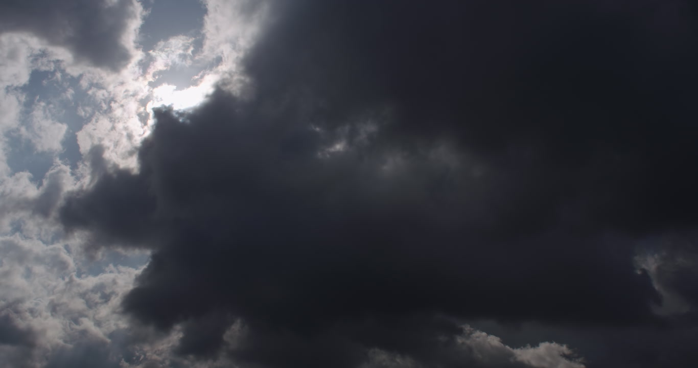 Dreamy, cinematic clouds - sun over storm clouds, colorful lens flares appear