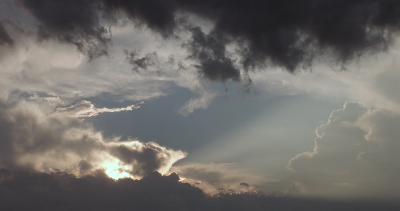 Dreamy, cinematic clouds - clouds drift by at sunset as storm approaches