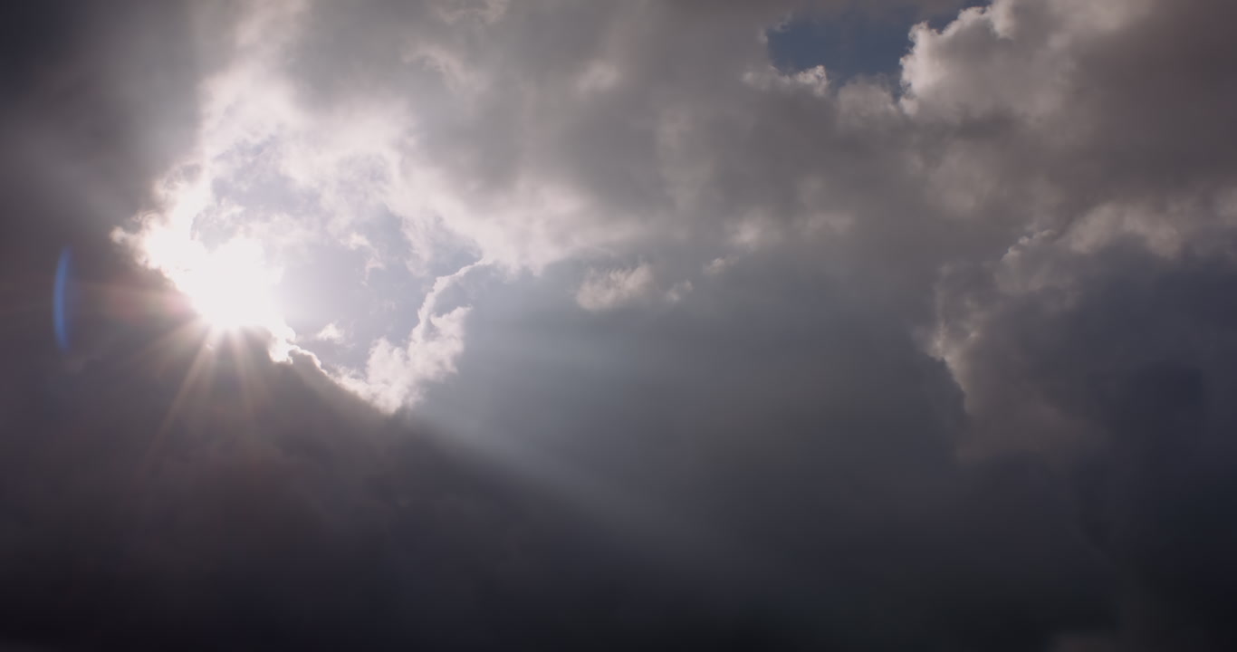 Dreamy, cinematic clouds - Huge sun rays appear from behind dark clouds