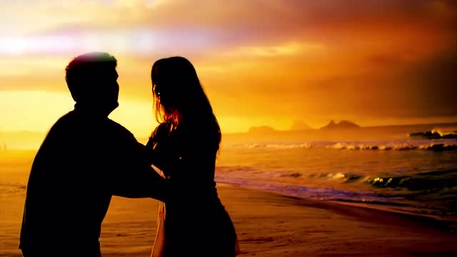 Brazilian couple embrace on a beach in Brazil