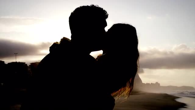 Brazilian couple embrace on a beach in Brazil