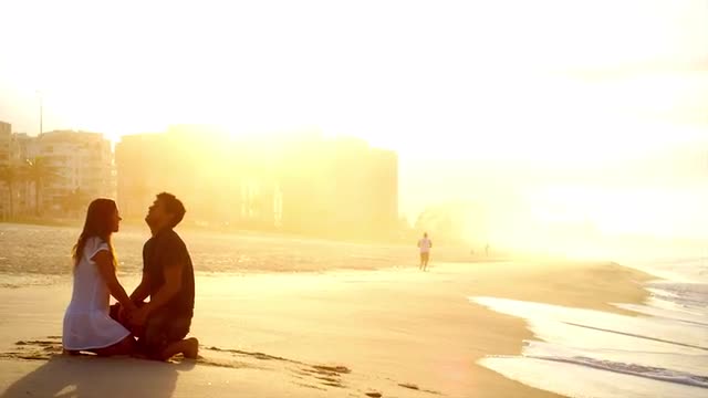 Brazilian couple embrace on a beach in Brazil