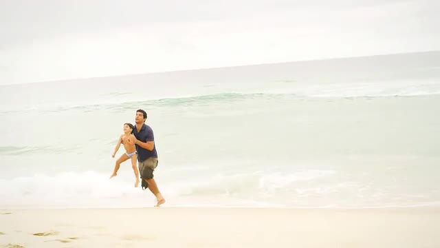 Brazilian Family plays on a beach in Brazil
