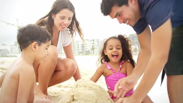 Brazilian Family plays on a beach in Brazil