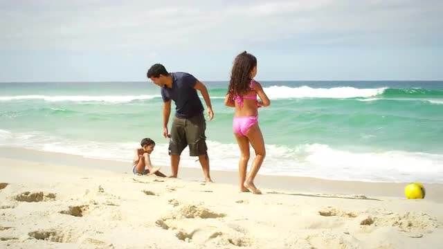 Brazilian Family plays on a beach in Brazil
