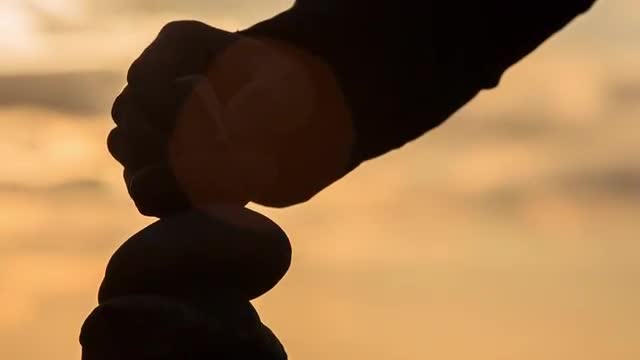 Guy Putting Stone On Stonetower