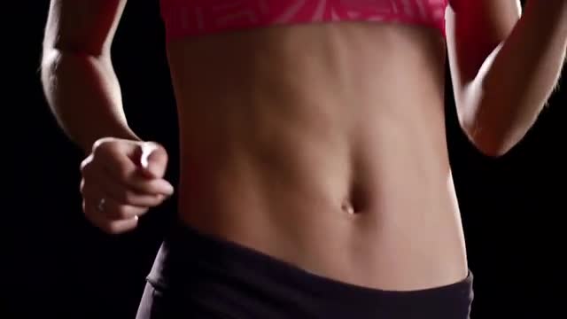 Black Woman jogging on a treadmill