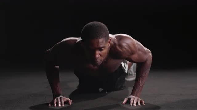 Muscular black man performing military push-ups