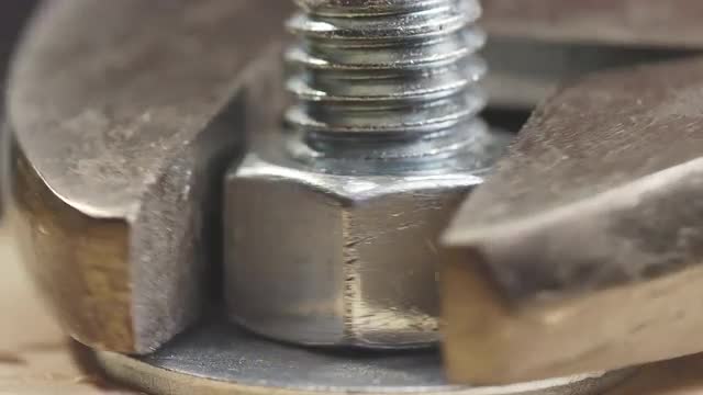 Wrench Tightening Bolt into Wood