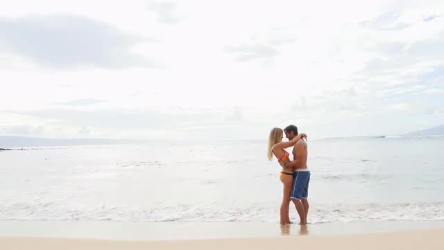 Couple embrace by the ocean