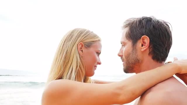 Couple embrace by the ocean