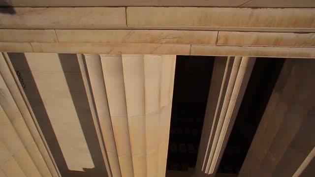 A tracking shot of a large pillar at the Lincoln Memorial in Washington DC.