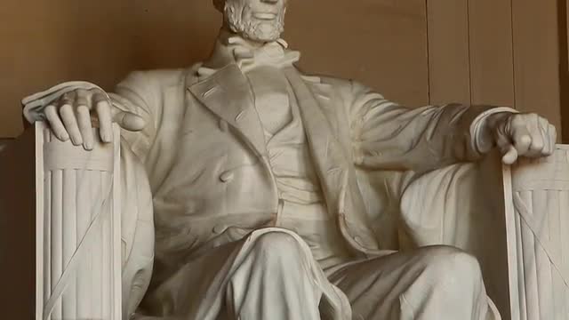 Tilting shot of the Abraham Lincoln statue inside the Lincoln Memorial in Washington DC