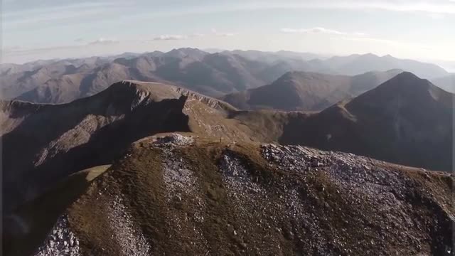 Spectacular aerial shot on Sgurr a'Mhaim mountain in the Scottish highlands during sunset