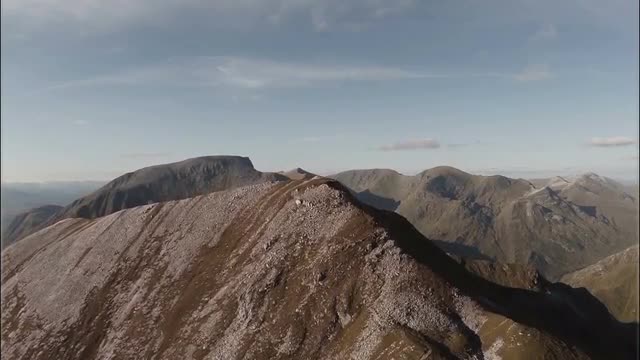 Spectacular aerial shot on Sgurr a'Mhaim mountain revealing Ben Nevis in the Scottish highlands 