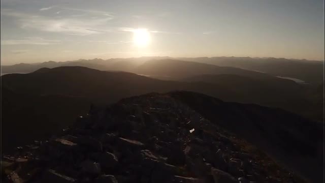 Spectacular aerial shot on Sgurr a'Mhaim mountain in the Scottish highlands during sunset