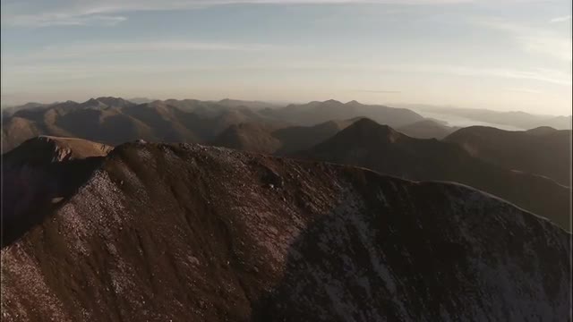 Spectacular aerial shot on Sgurr a'Mhaim mountain in the Scottish highlands during sunset