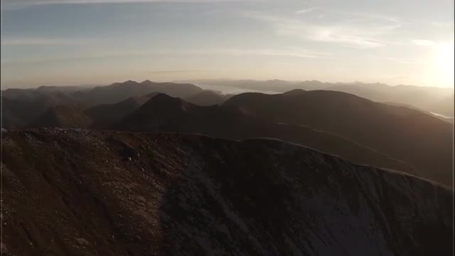 Spectacular aerial shot on Sgurr a'Mhaim mountain in the Scottish highlands during sunset