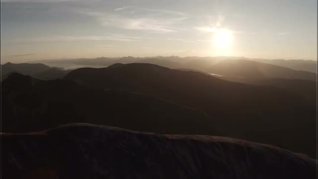 Spectacular aerial shot on Sgurr a'Mhaim mountain in the Scottish highlands during sunset